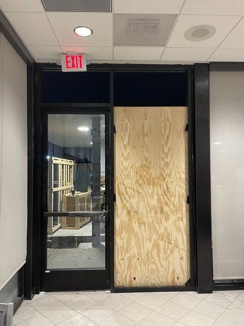 Emergency plywood board-up of a glass entrance by Mars Glass